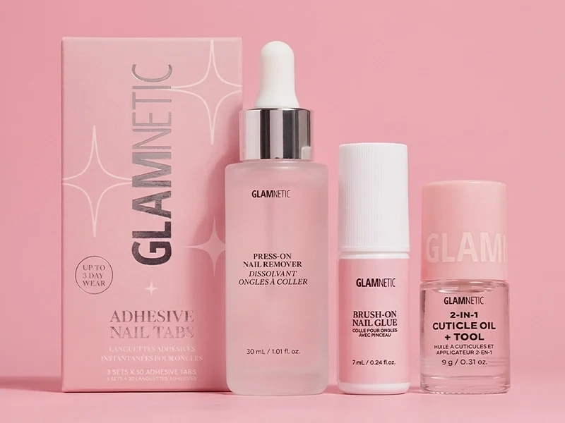 Glamnetic nail care accessories and adhesive nail tabs on a pink background