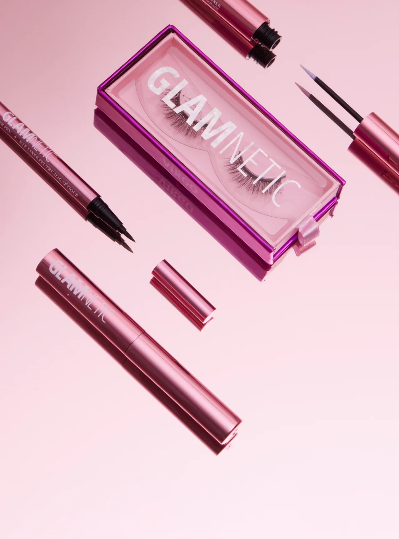 Glamnetic magnetic eyeliner set with pink case on a matching pink background