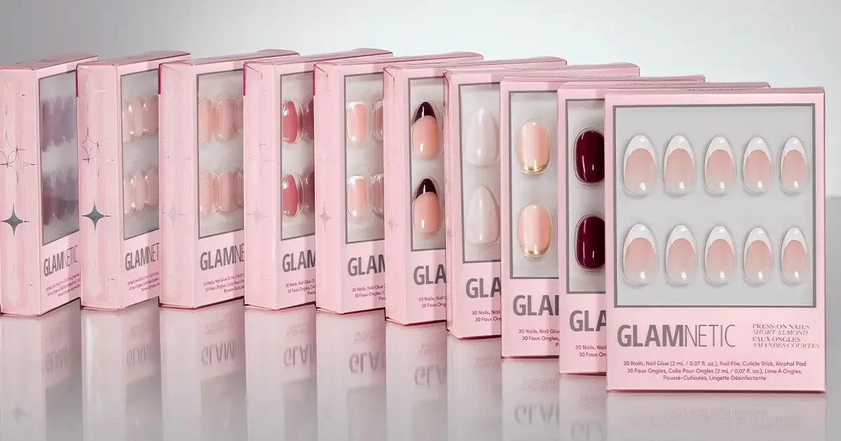 A row of Glamnetic press-on nail boxes in pink packaging