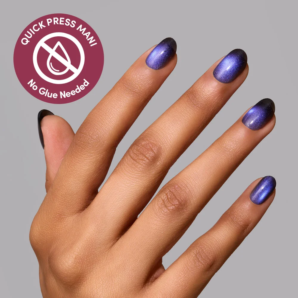Hand wearing Deep Winter Quick Press Mani, extra short round nails in black with an electric blue velvet shimmer