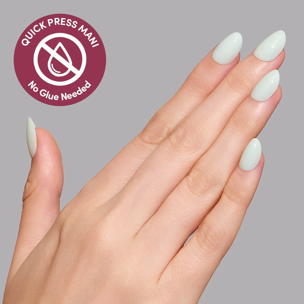 Hand wearing Minty Cloud Quick Press Mani, extra short oval nails in a cool mint green